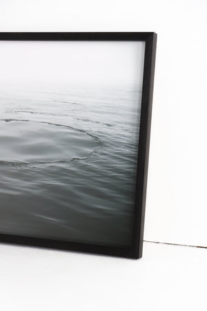 Water ripples framed in black frame